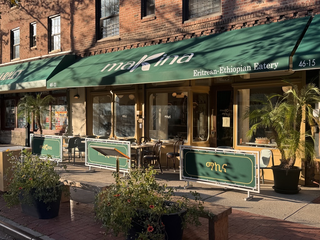 Makina's Sunnyside patio at midday, tables and chairs set out along the sidewalk