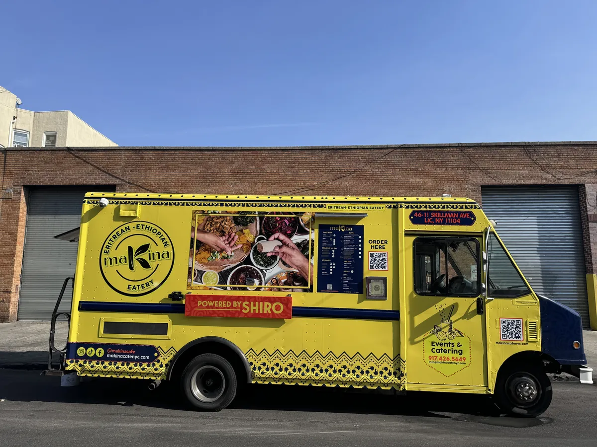 The yellow Makina Eritrean-Ethiopian food truck, ready to book for events and catering in New York